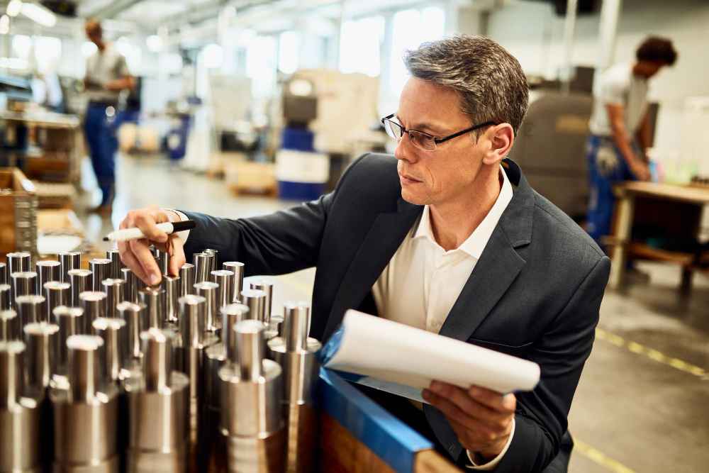 How to select a material for an industrial application Engineer inspecting metal components during the material selection process for an industrial application