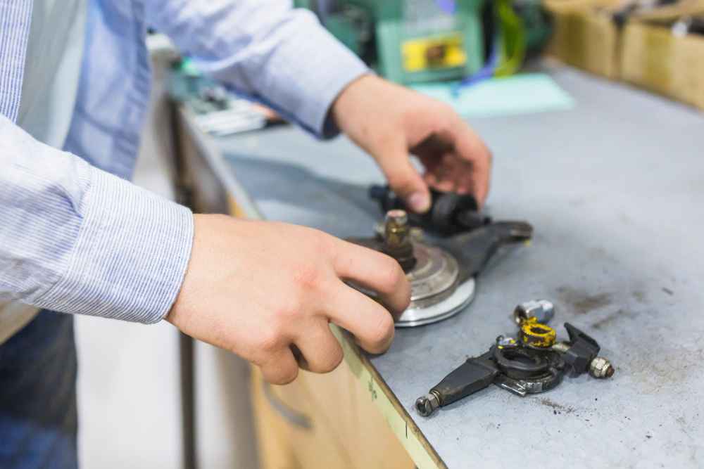 How to prevent failures in industrial products before they occur Technician inspecting mechanical components to detect potential failures in industrial products