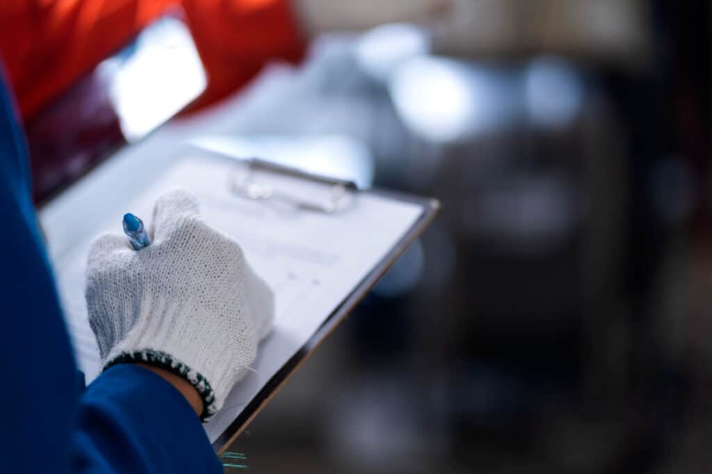 Engineer recording data during a failure investigation in an industrial process