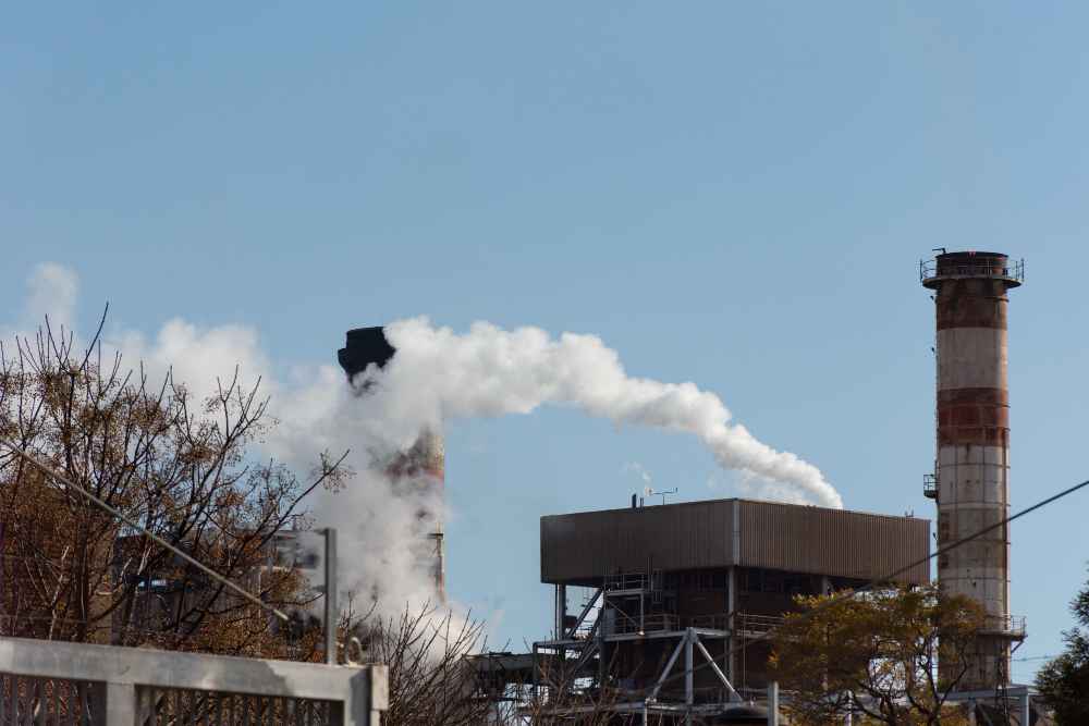 Comparative testing of technologies to eliminate industrial odors Industrial chimneys emitting visible gases associated with emissions and potential industrial odors in production facilities