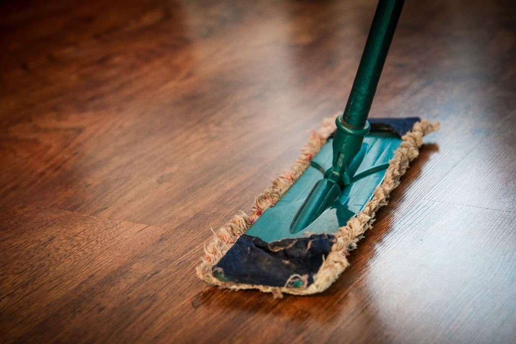 Cleaning of a delicate floor with a mop to assess compatibility of disinfectant solutions in a comparative benchmarking study